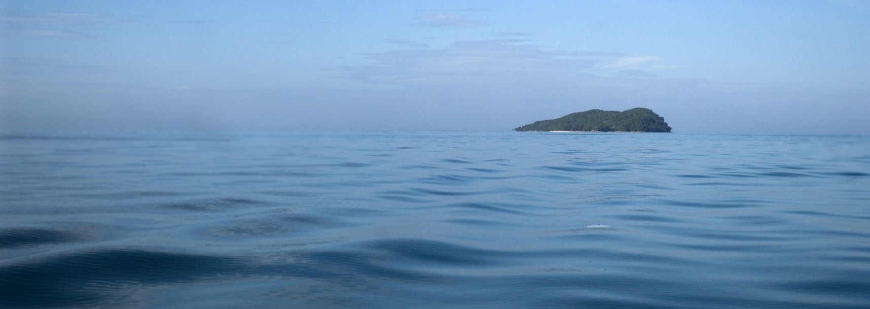 Header Image of a Rock Island surrounded by water